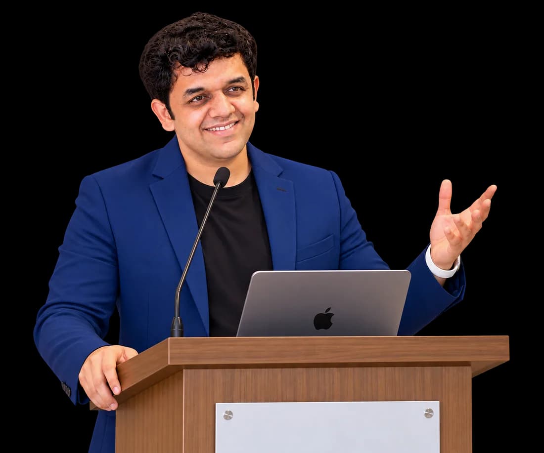 Siddhesh Joglekar speaking at a podium during a session