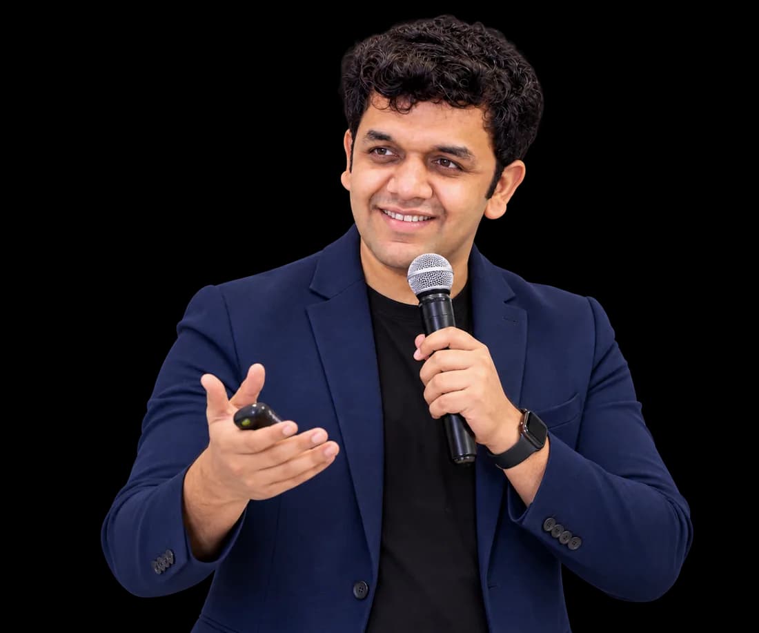Siddhesh Joglekar speaking with a microphone during a session
